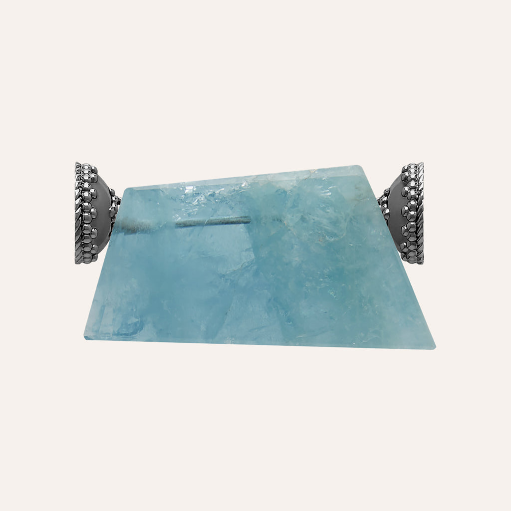 a blue pillow sitting on top of a table 